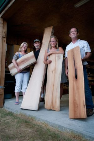Cindi Dormer, Tony Dormer, Dianne Hoegler and Jedson Smuck of Deep Water Wood show off wood planks retrieved from the depths of Georgian Bay. Photo by Rosemary Hasner / Black Dog Creative Arts.
