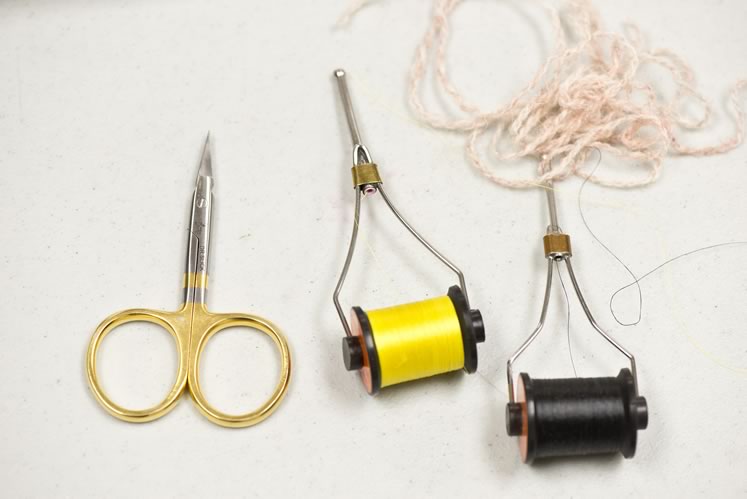 Tools of the trade include bobbins, wool yarn and scissors. Photo by Pete Paterson.