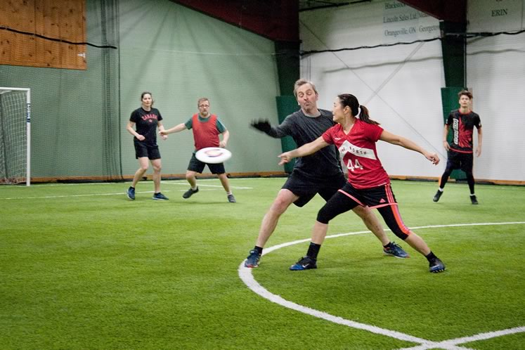 Ultimate champion Monica Kerr-Coster defends against an opponent at a recent indoor pickup game in Erin. Photo by Rosemary Hasner / Black Dog Creative Arts.